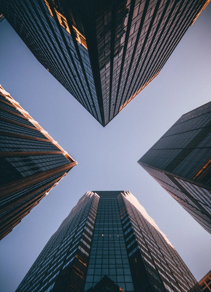 low-angle photography of four high-rise buildings